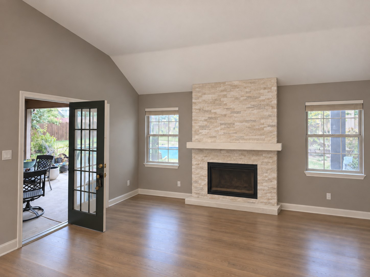 Wide room view showing the raised stone hearth and mantel shelf